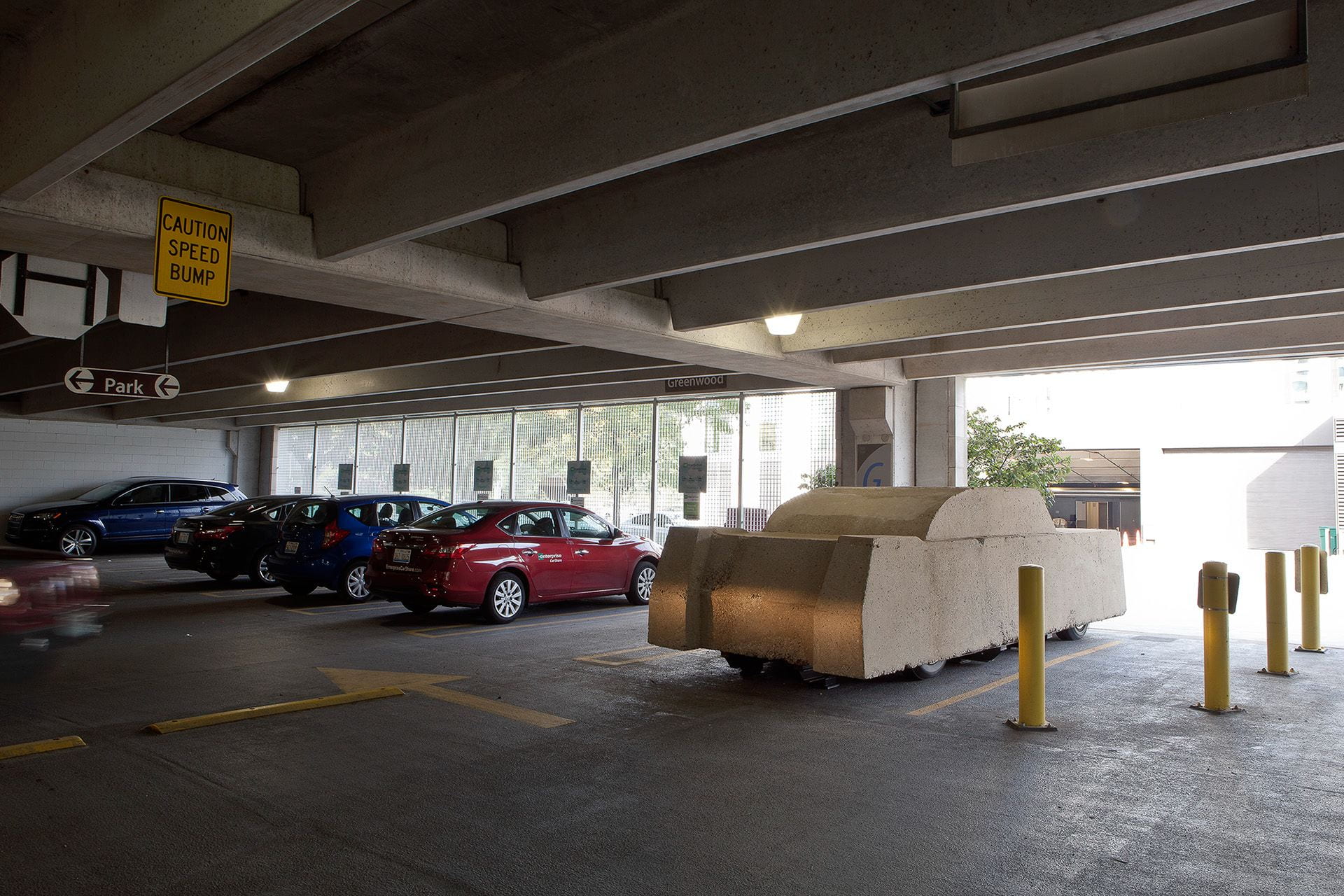 A concrete car parked in a parking garage