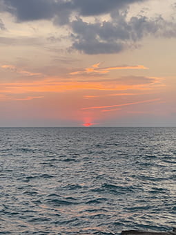 A rosy sunrise over choppy water of Lake Michigan